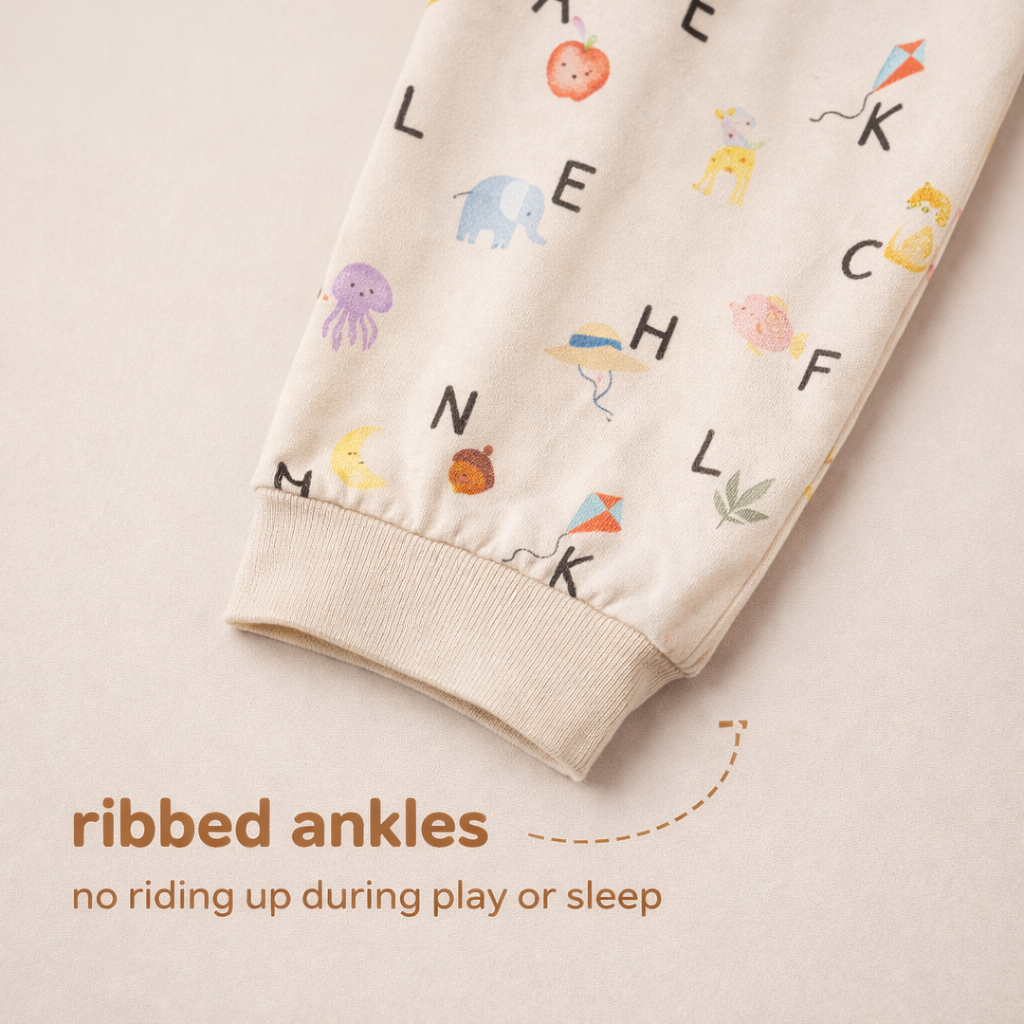 Children's bamboo pants with alphabet and animal patterns on a beige background