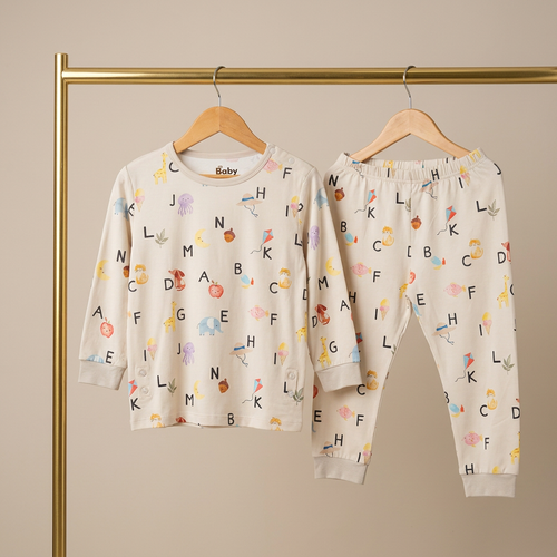Children's bamboo pajama set with alphabet pattern on a beige background