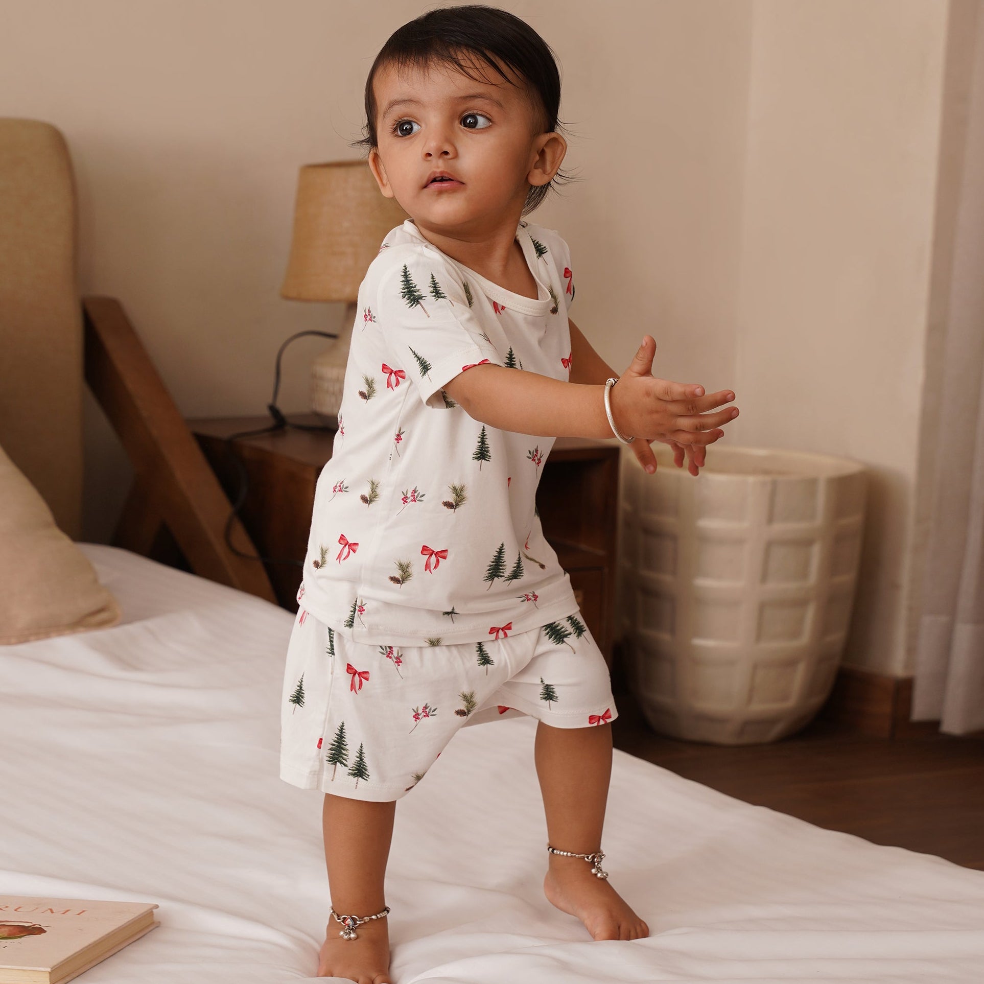 Toddler standing on bed in a bamboo co-ord set