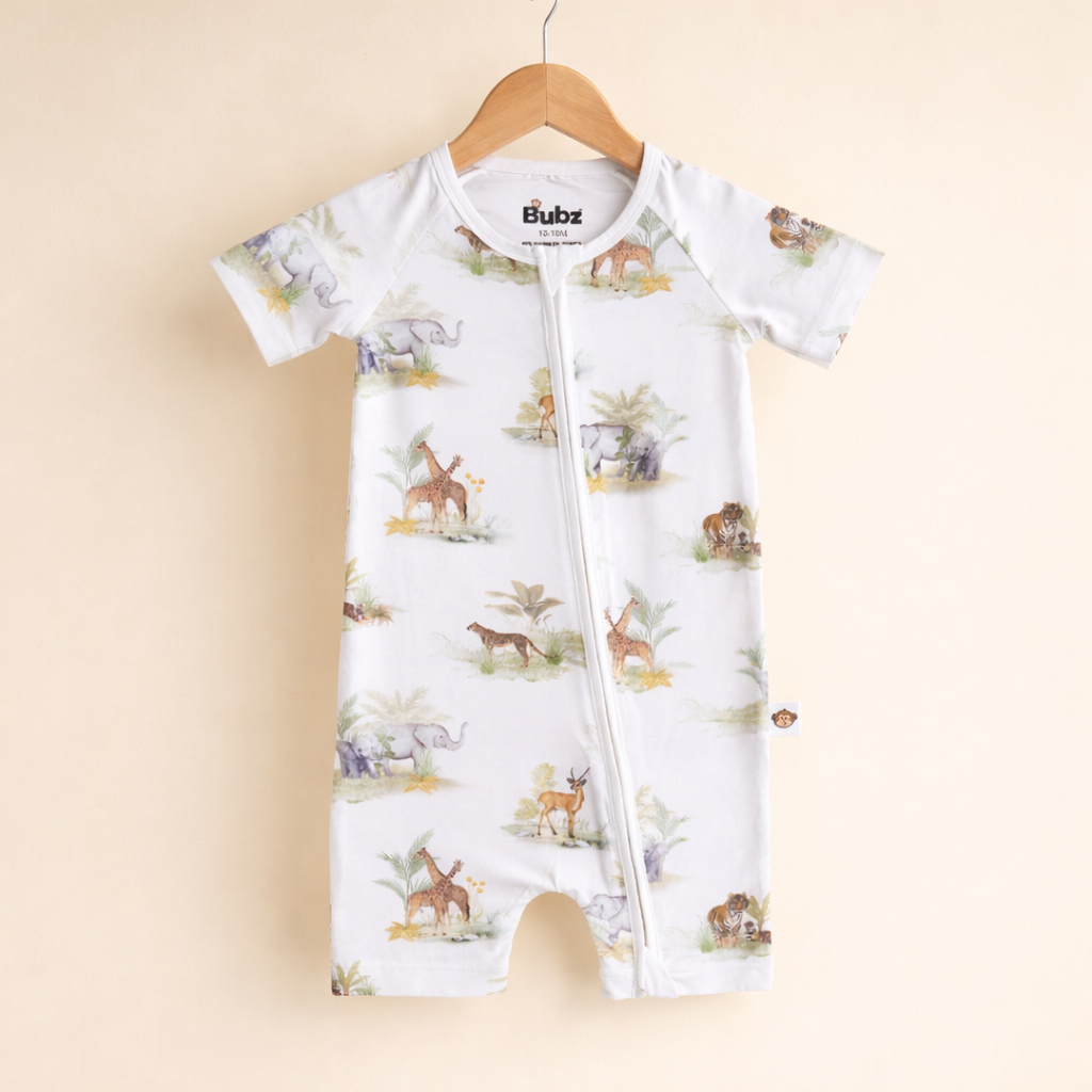 Baby onesie with animal pattern on a beige background