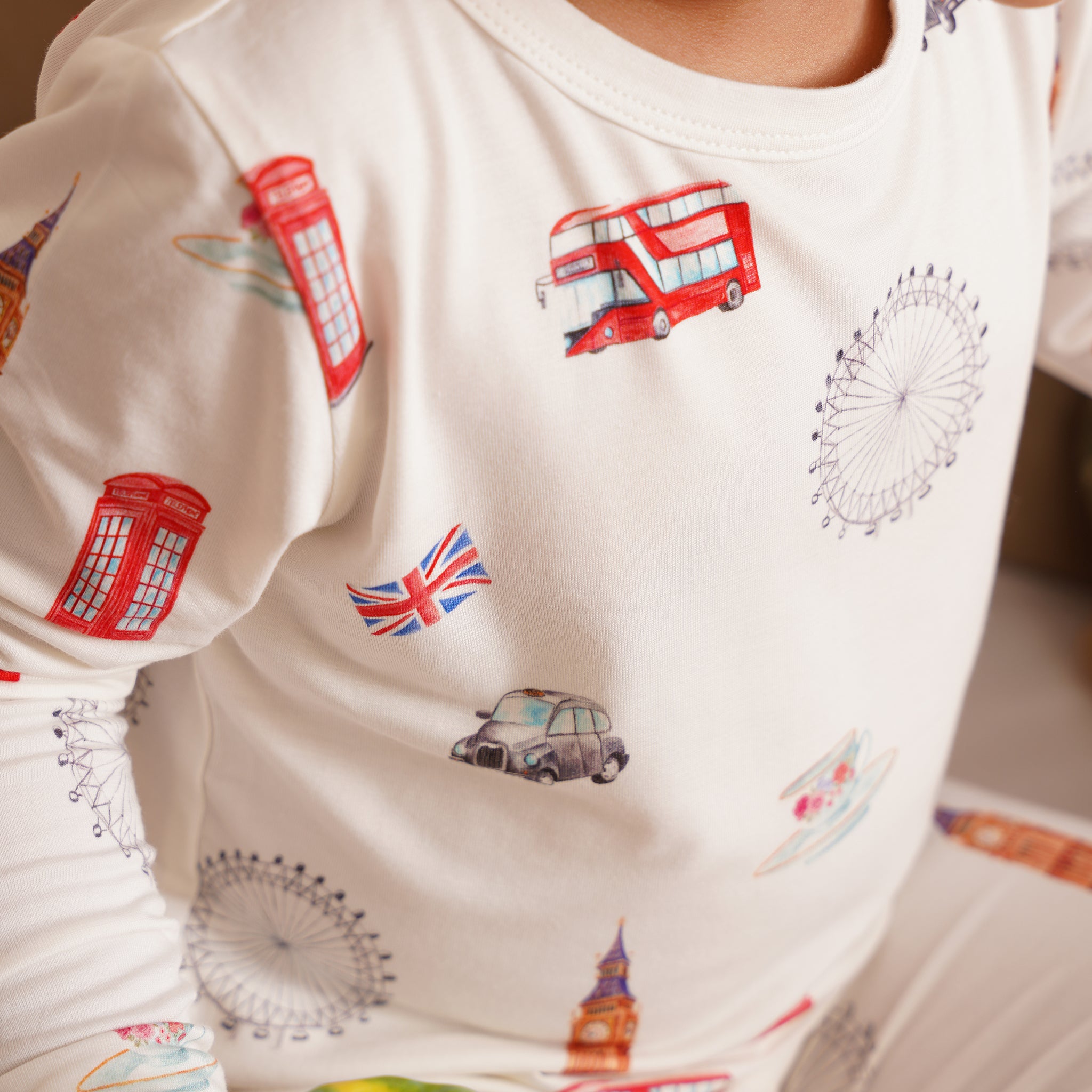 Children's outfit with London-themed illustrations on a white background