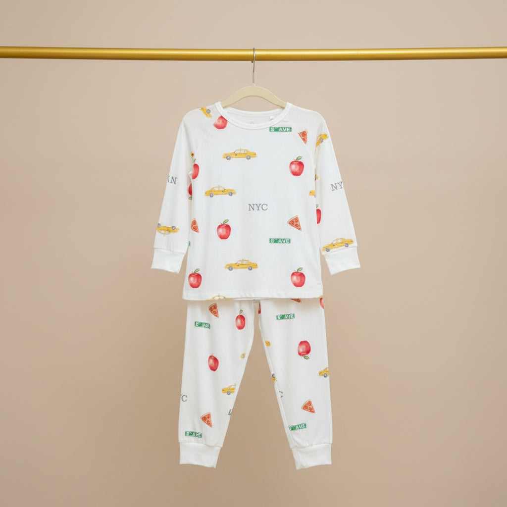 Children's pajama set with car and apple pattern on a beige background