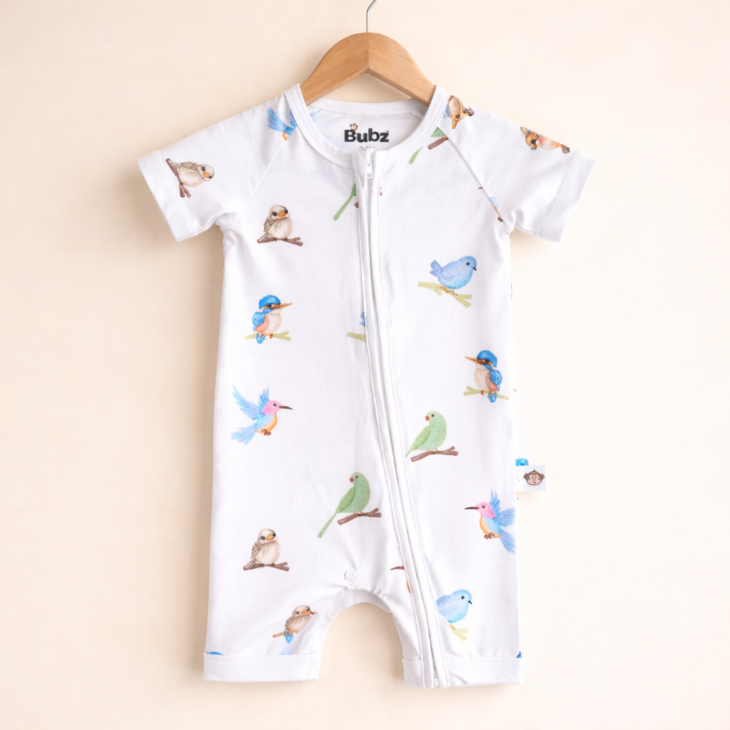 Baby romper with bird pattern on a beige background