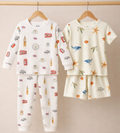 Two sets of children's pajamas on hangers against a beige background