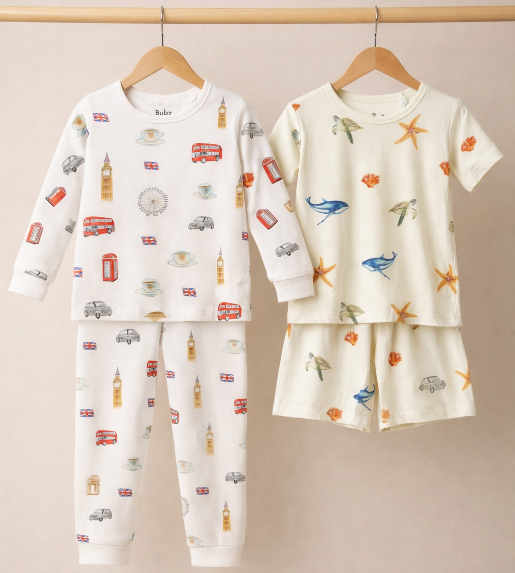 Two sets of children's pajamas on hangers against a beige background