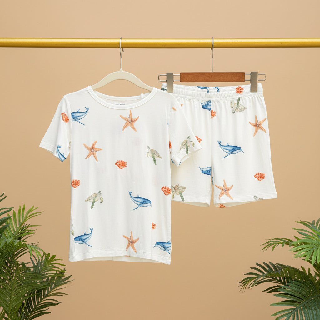 Children's pajama set with sea-themed pattern on a beige background