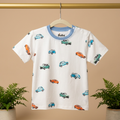 Children's bamboo t-shirt with car pattern on a hanger against a beige background
