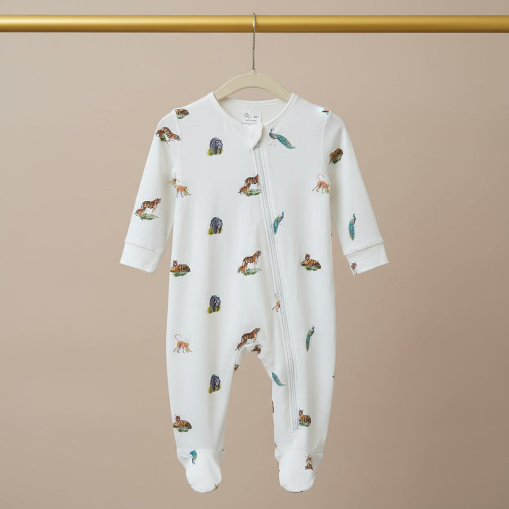 Baby onesie with animal pattern on a hanger against a beige background